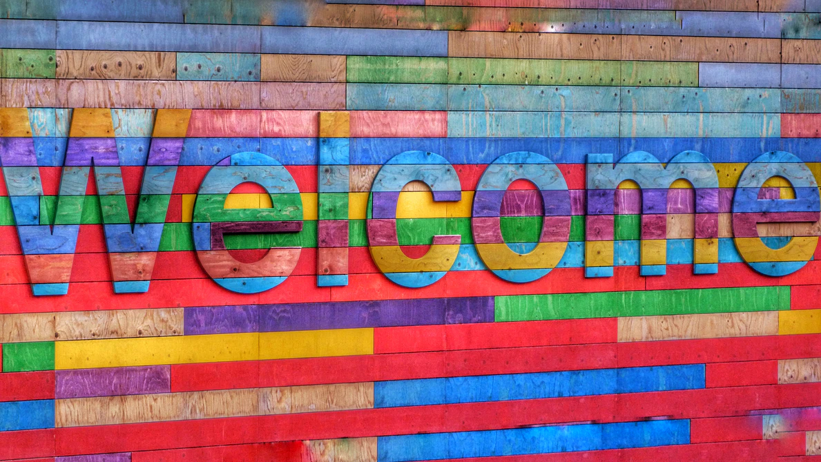 Colorful welcome sign on wood block wall