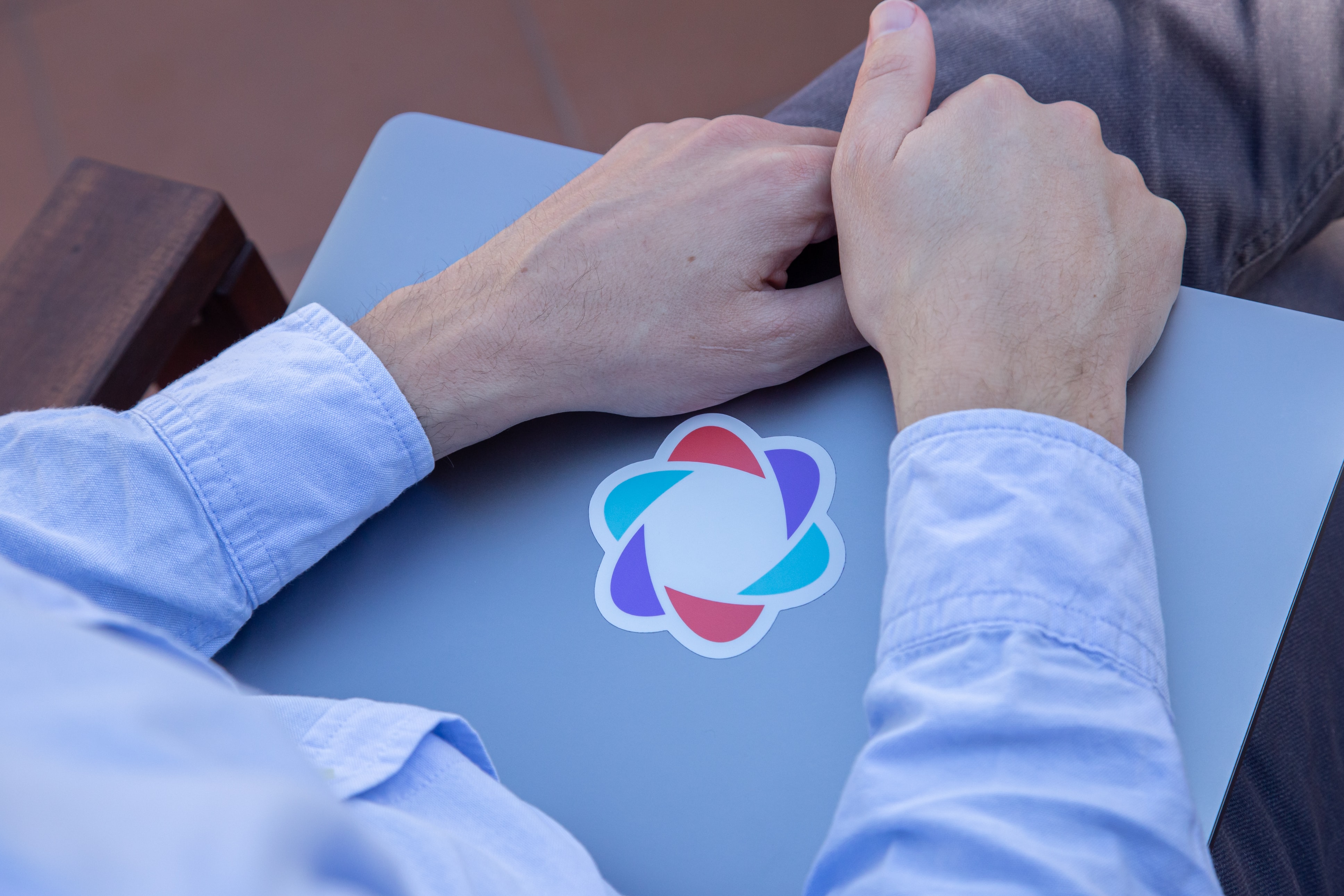 a person holds a laptop with the parabol logo on it