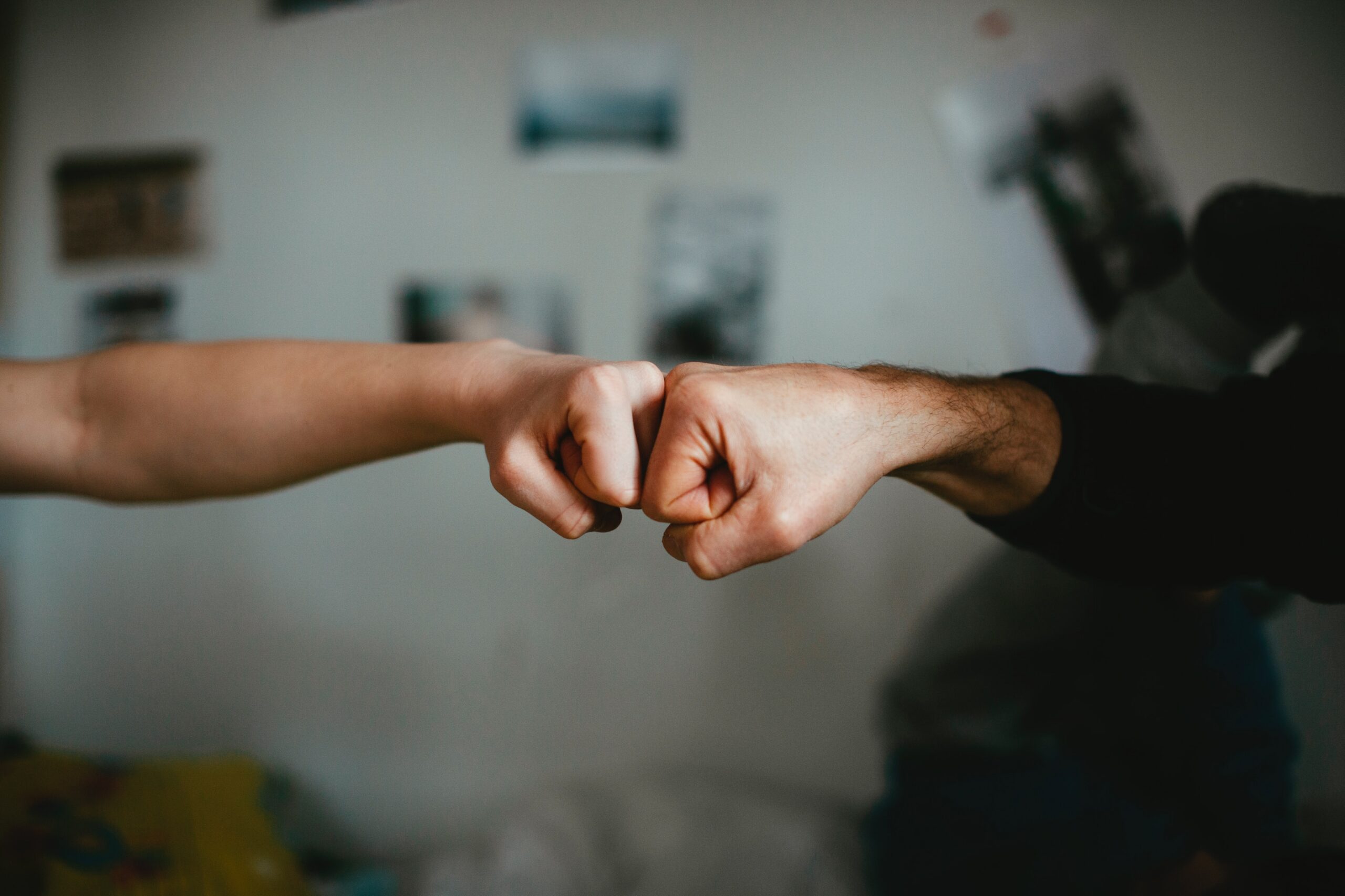 Two hands fist bumping