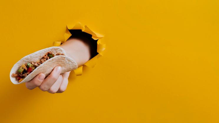 close-up-hand-holding-taco-with-copy-space