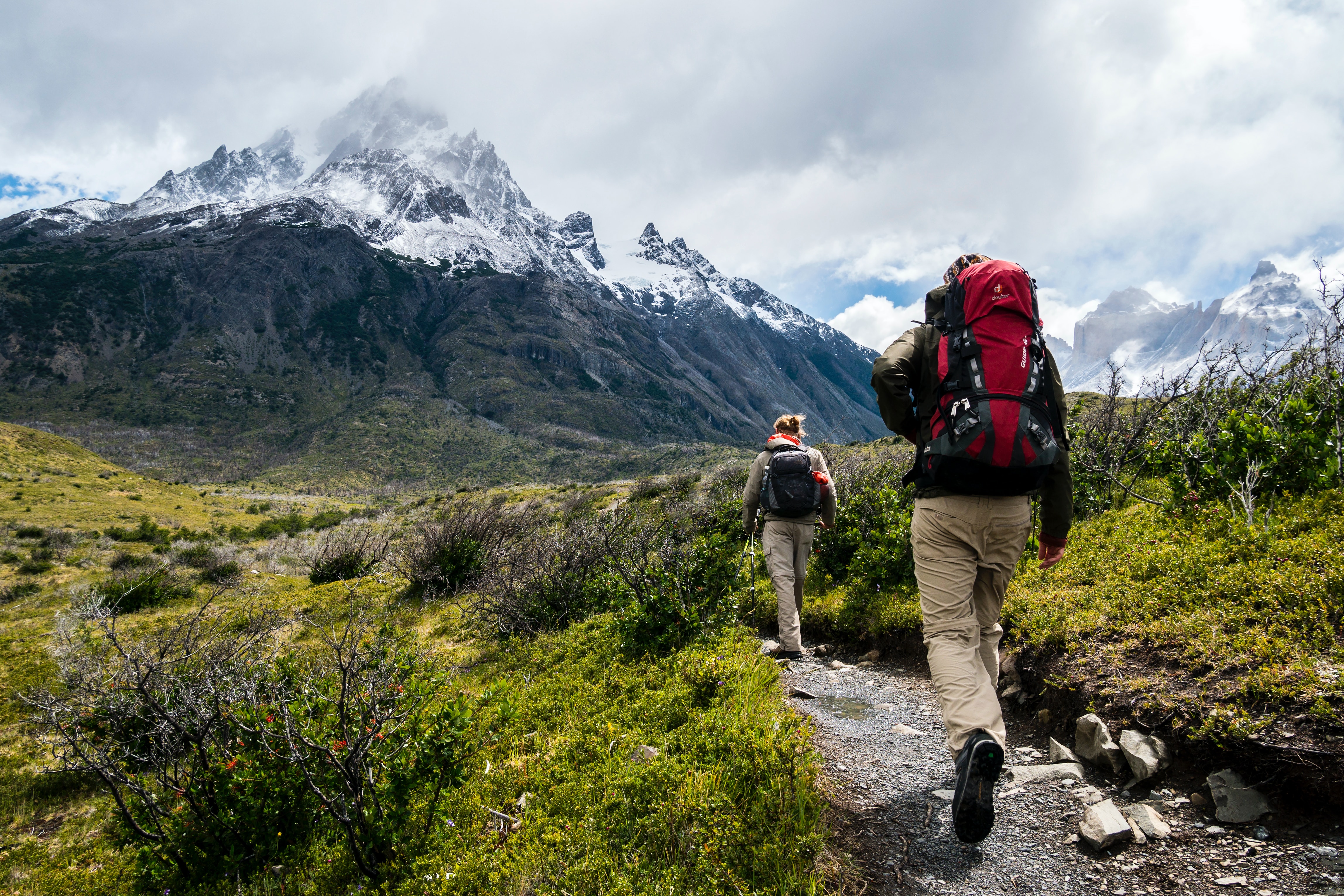 Two people hiking toward a mountain
