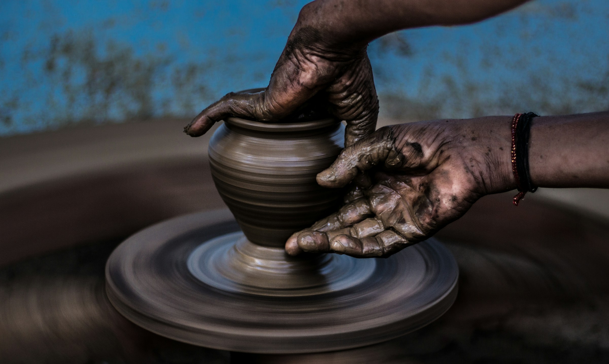 Hands forming pottery
